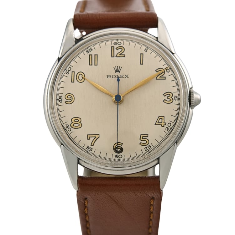 A vintage Rolex Oyster 4219 wristwatch with a brown leather strap and gold numerals on a silver dial.