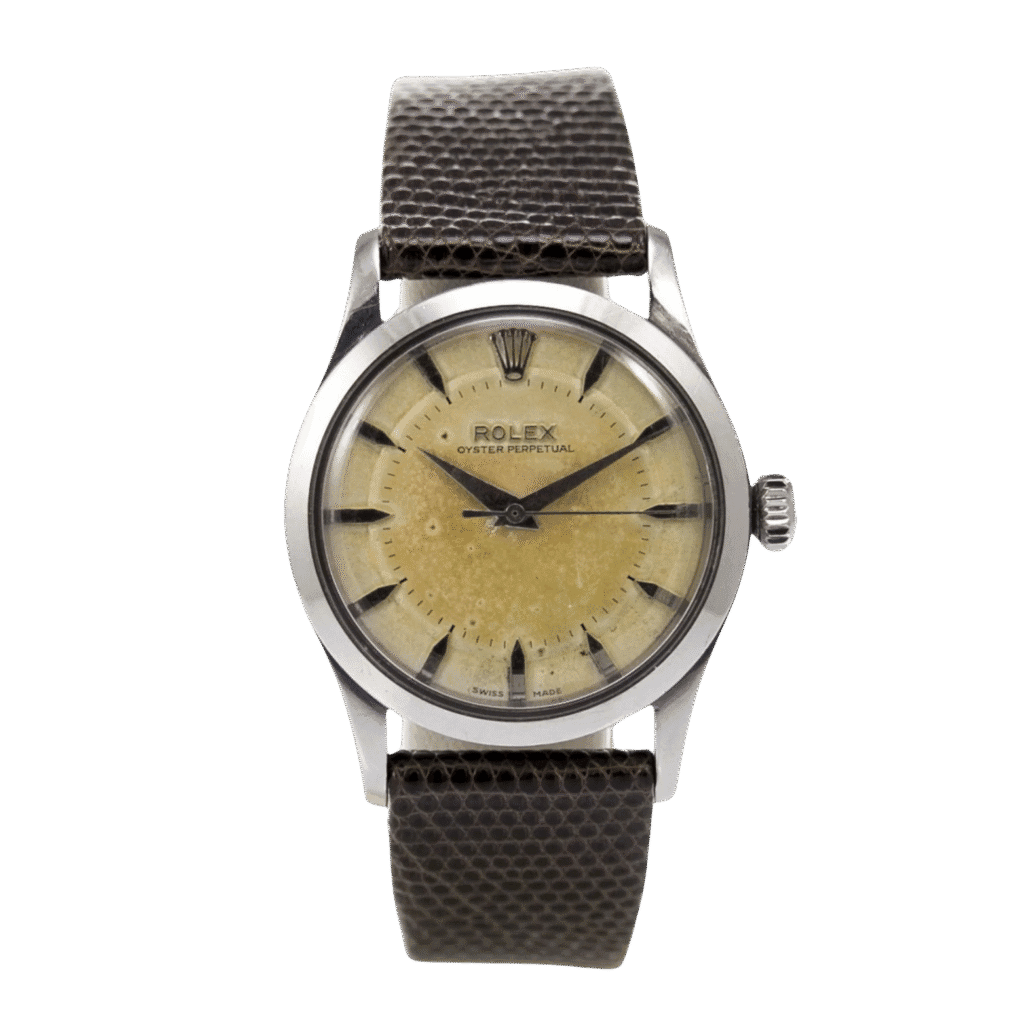 Vintage Rolex Oyster Perpetual wristwatch, ref. 6332, featuring a beige dial, black markers, and a textured dark leather strap.