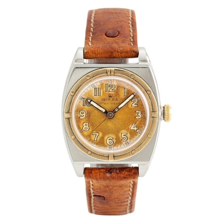 Vintage Rolex Oyster 3359 wristwatch with a brown leather strap and a golden dial featuring Arabic numerals.
