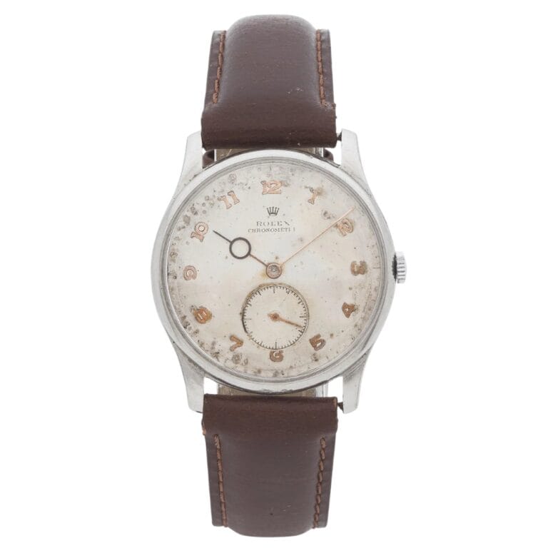 Vintage wristwatch with a worn white dial, Arabic numerals, and a brown leather strap.