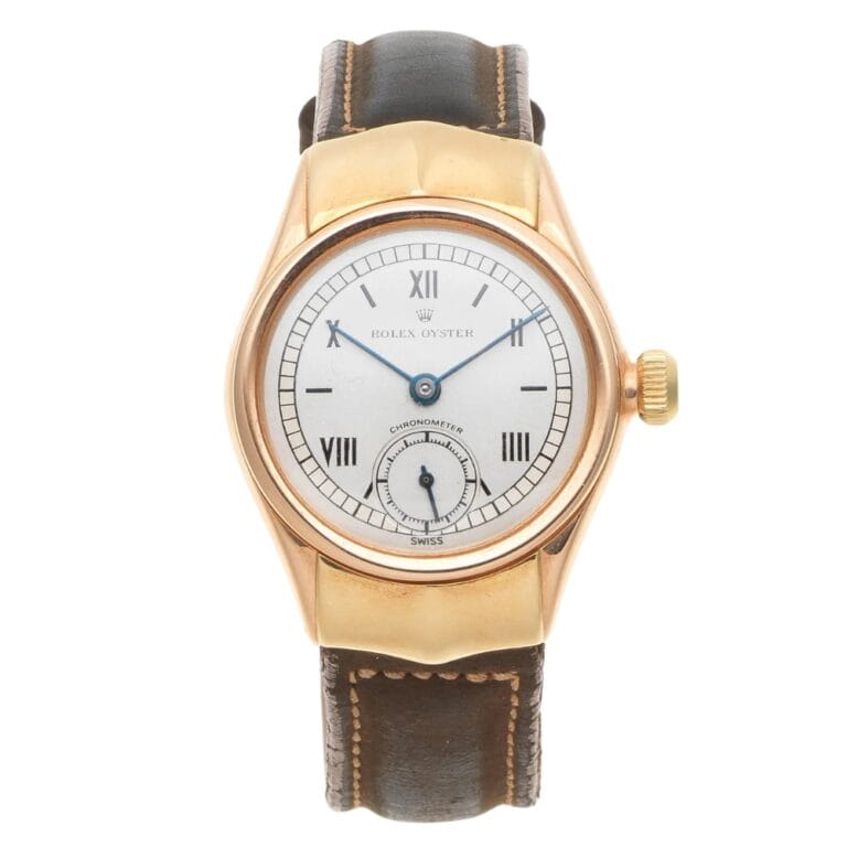 Gold Rolex Oyster 3270 watch with a white dial, blue hands, Roman numerals, and a brown leather strap.