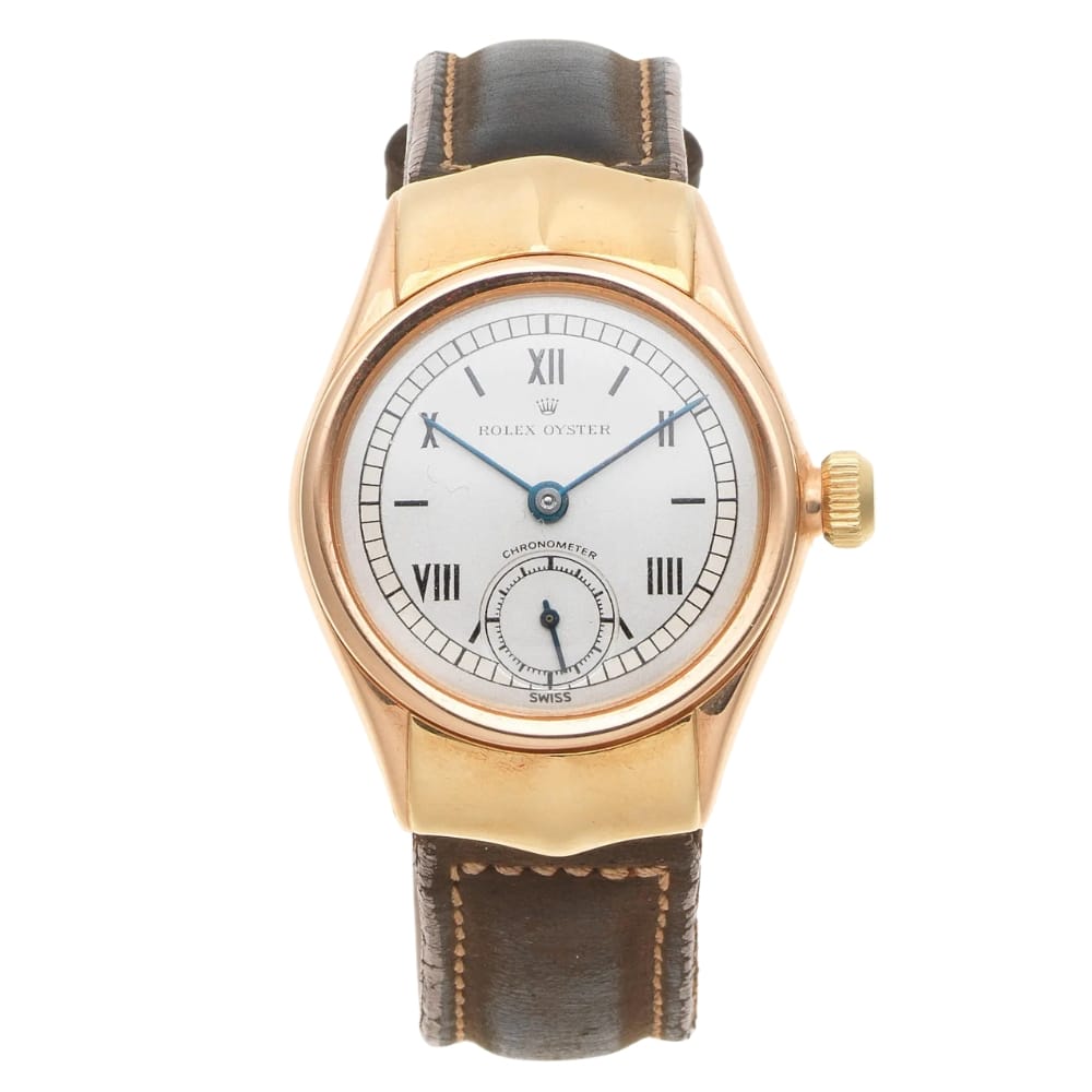Gold Rolex Oyster 3270 watch with a white dial, blue hands, Roman numerals, and a brown leather strap.