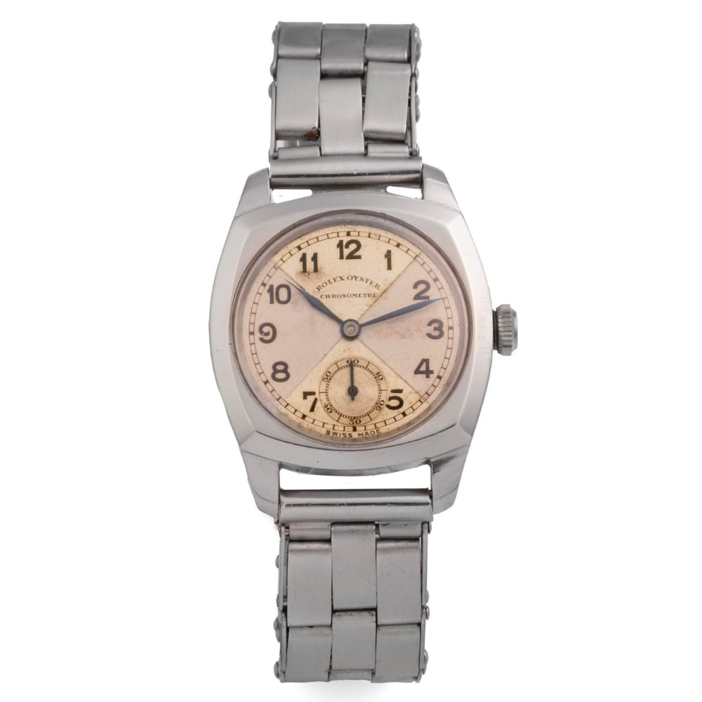 A vintage Rolex watch with a cream dial, black numerals, and a classic metal link band—timeless style inspired by the renowned Oyster 3139.