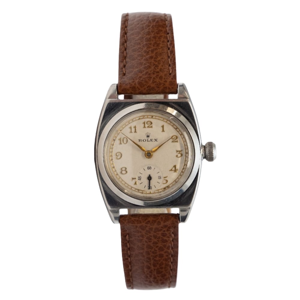 Vintage Rolex Oyster 3116 wristwatch with a brown leather strap and a cream-colored dial featuring Arabic numerals.