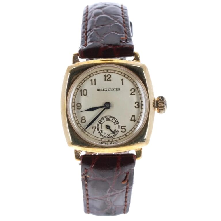 Vintage Rolex Oyster 2416 watch with a square gold case and brown leather strap, displaying Arabic numerals.