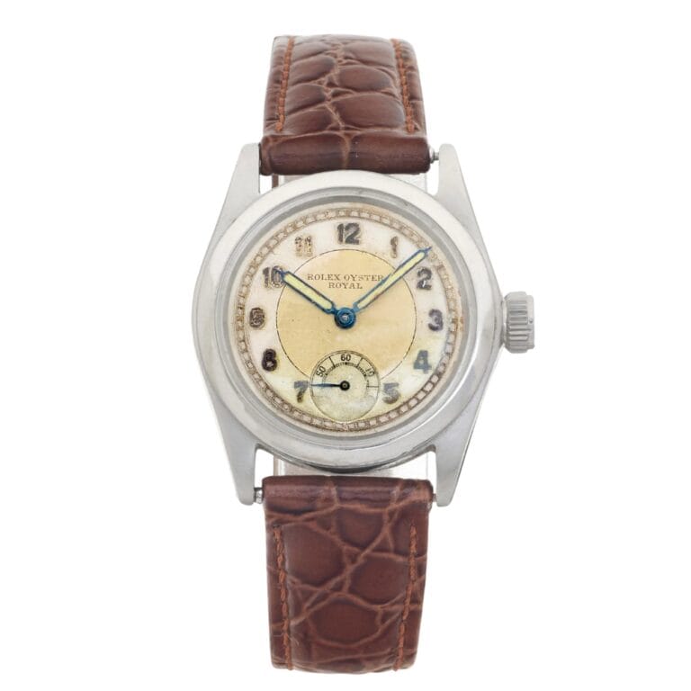 Vintage Rolex Oyster Royal 2280 watch with a brown leather strap and silver round case, elegantly displaying the time.