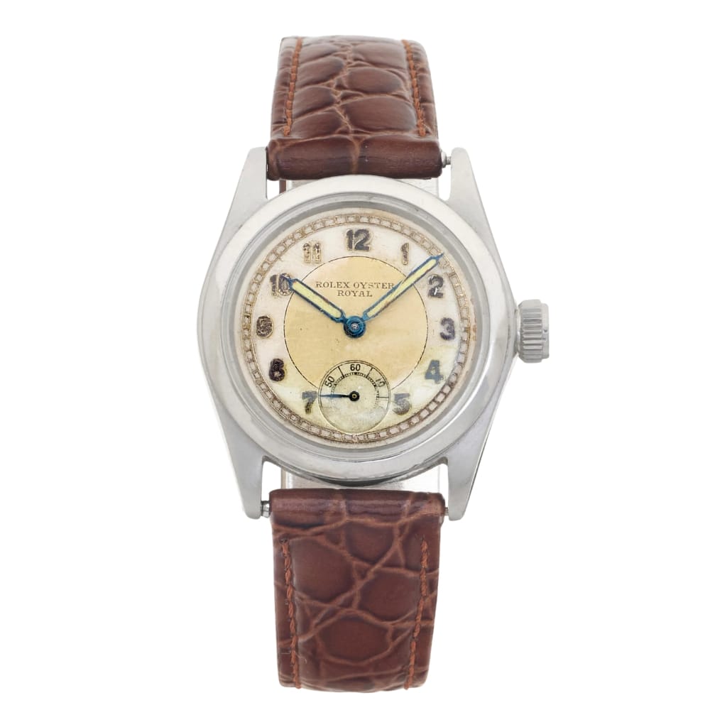 Vintage Rolex Oyster Royal 2280 watch with a brown leather strap and silver round case, elegantly displaying the time.