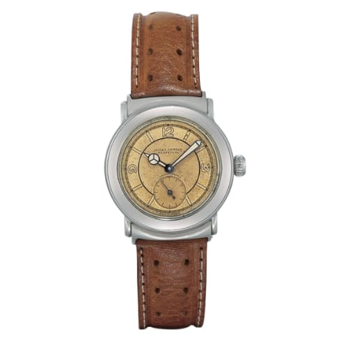 A vintage Rolex Oyster Perpetual wristwatch with a tan leather strap and a round beige dial featuring black numerals and hands, referencing the classic 3538 model.