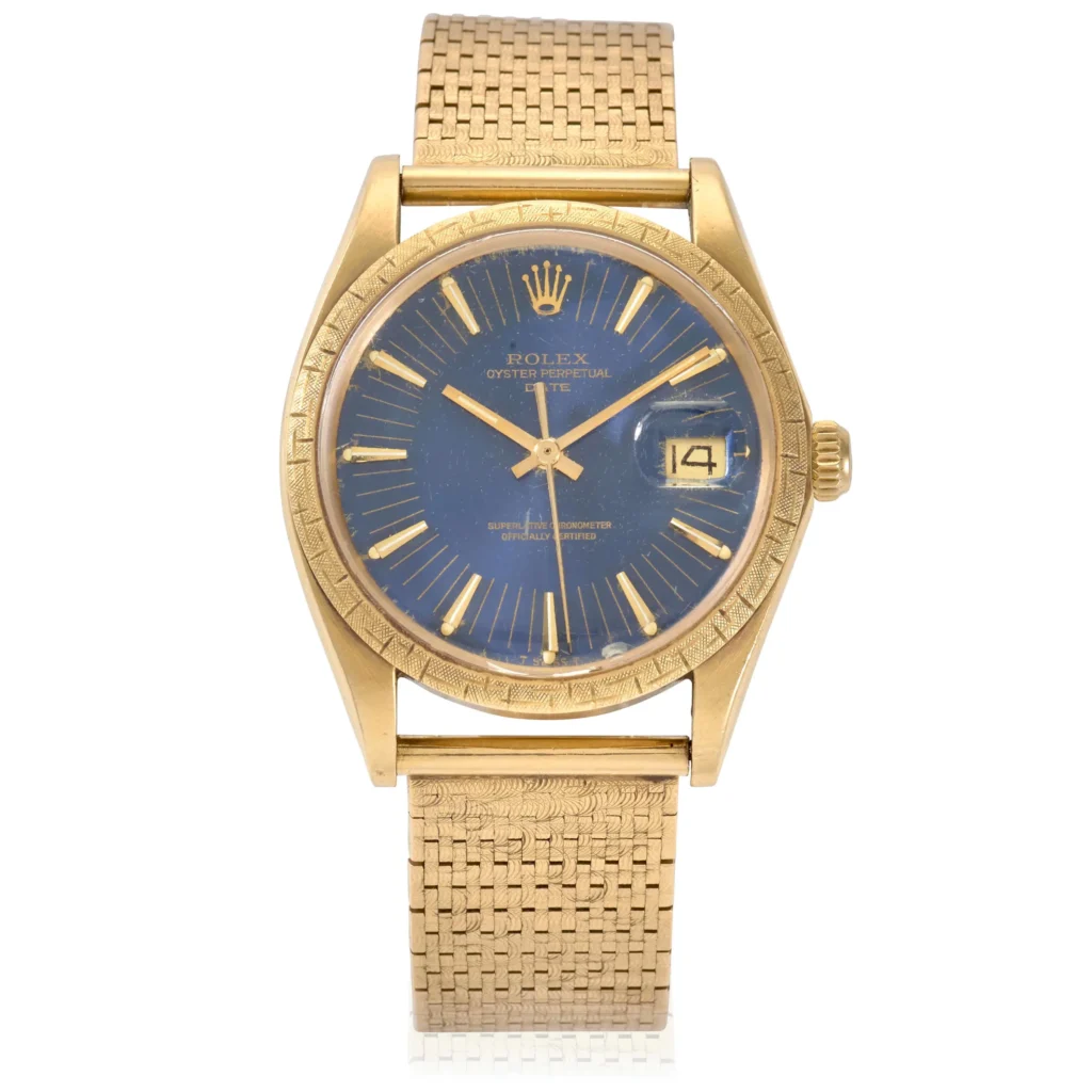Gold Rolex Oyster Perpetual Date 1504 wristwatch with a blue dial, Roman numerals, date window, and a gold mesh band.
