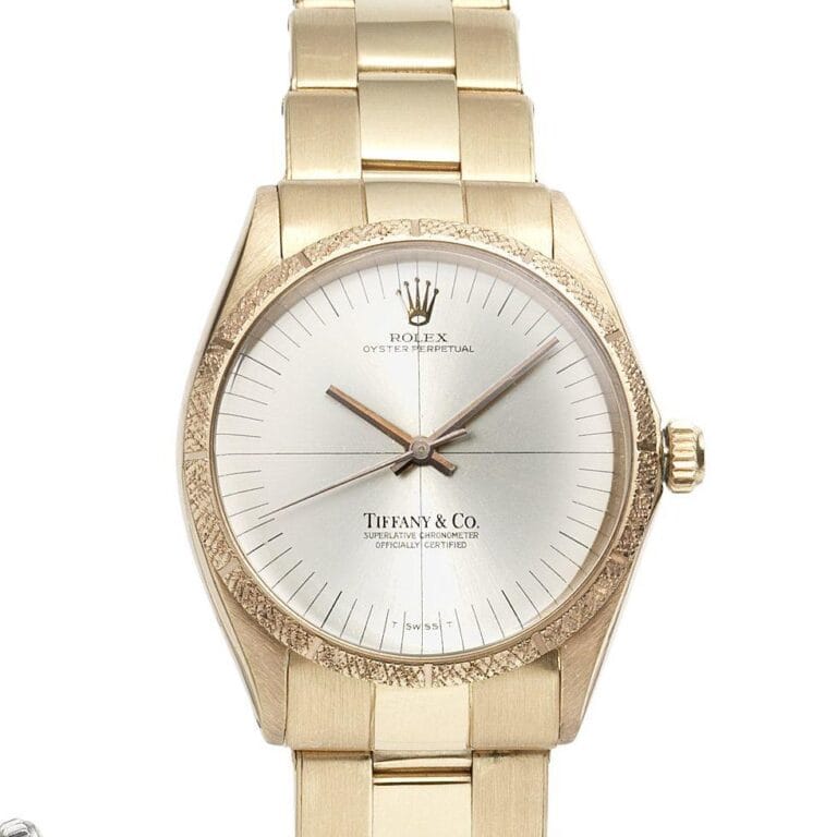 Gold Rolex Oyster Perpetual wristwatch, model 1029, featuring a silver dial with Tiffany & Co. branding on the face.