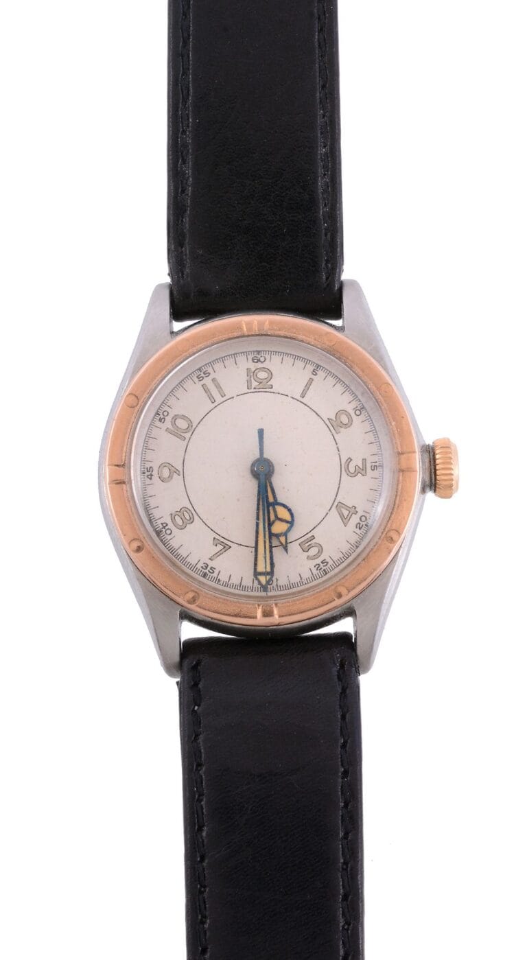 A vintage Rolex Oyster Perpetual wristwatch with a black leather strap and a round, silver and gold bezel.
