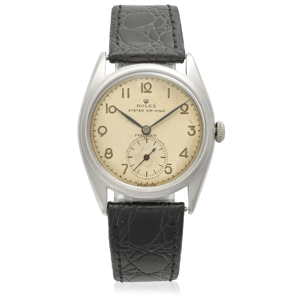 Rolex Oyster Air-King 4365 wristwatch with a beige dial and black leather strap, featuring a small seconds subdial.