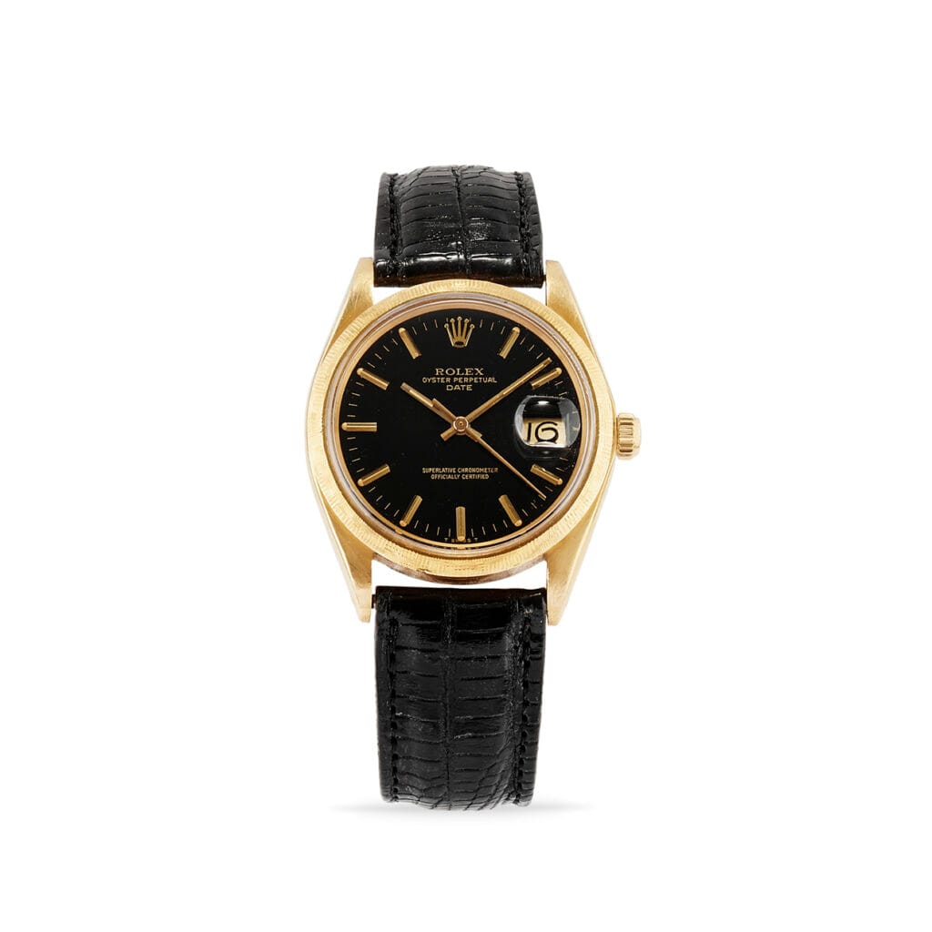 Gold Rolex Oyster Perpetual watch with a black dial, date display, and black leather strap, shown on a white background.