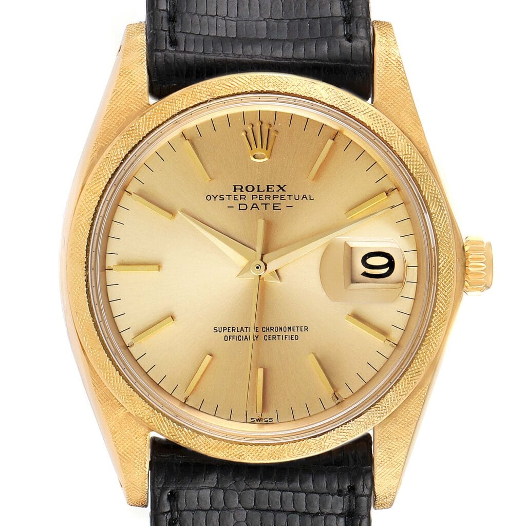 Gold Rolex Oyster Perpetual Date 1502 watch with a black leather strap, gold dial, and date window showing the number 9.