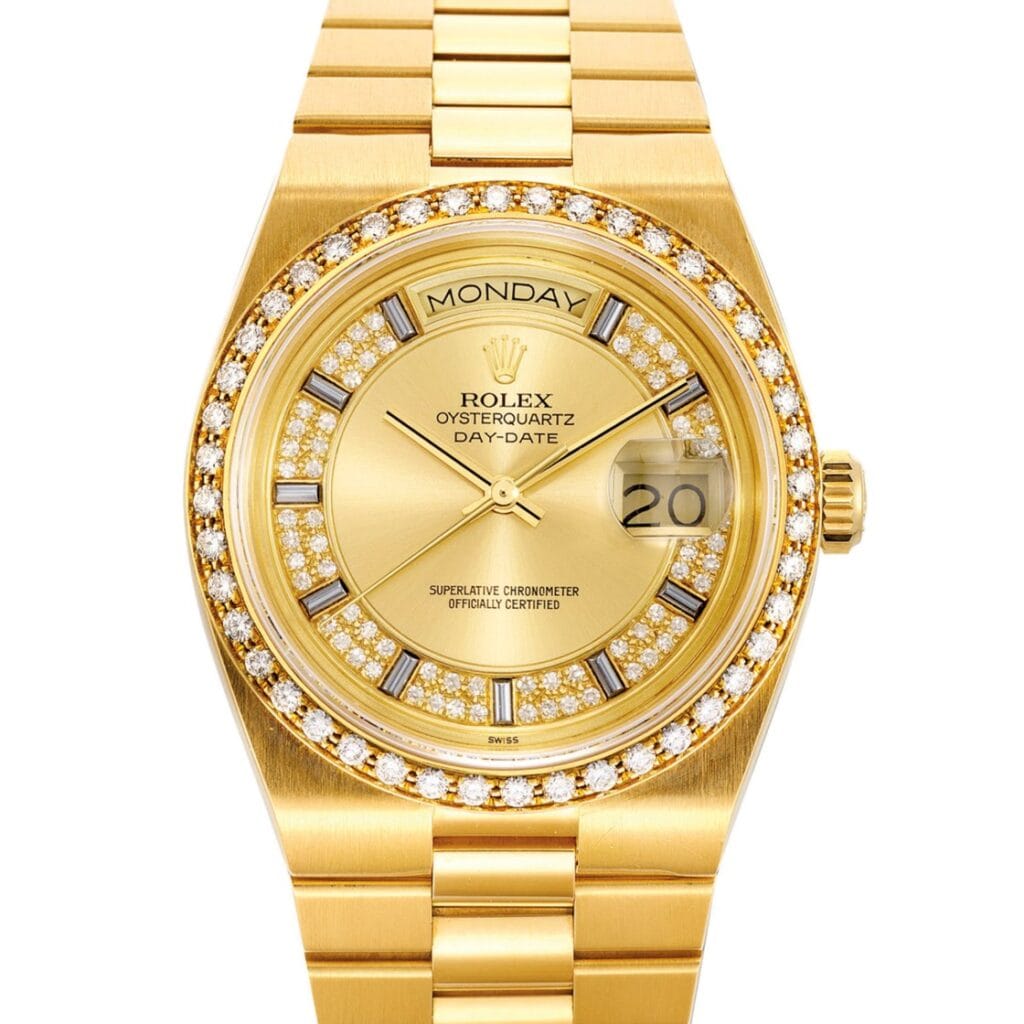 Gold Rolex Oysterquartz Day-Date 19048 watch with diamond bezel and markers, displaying Monday and the date 20.