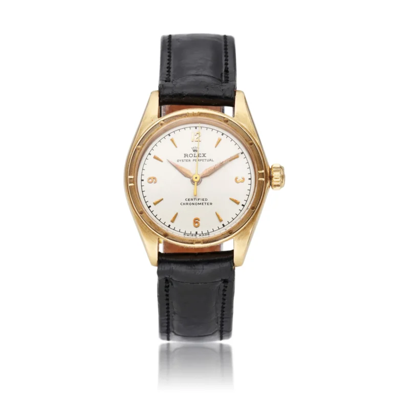 Gold Rolex Oyster Perpetual wristwatch with a white dial, black leather strap, and gold accents, displayed on a white background.