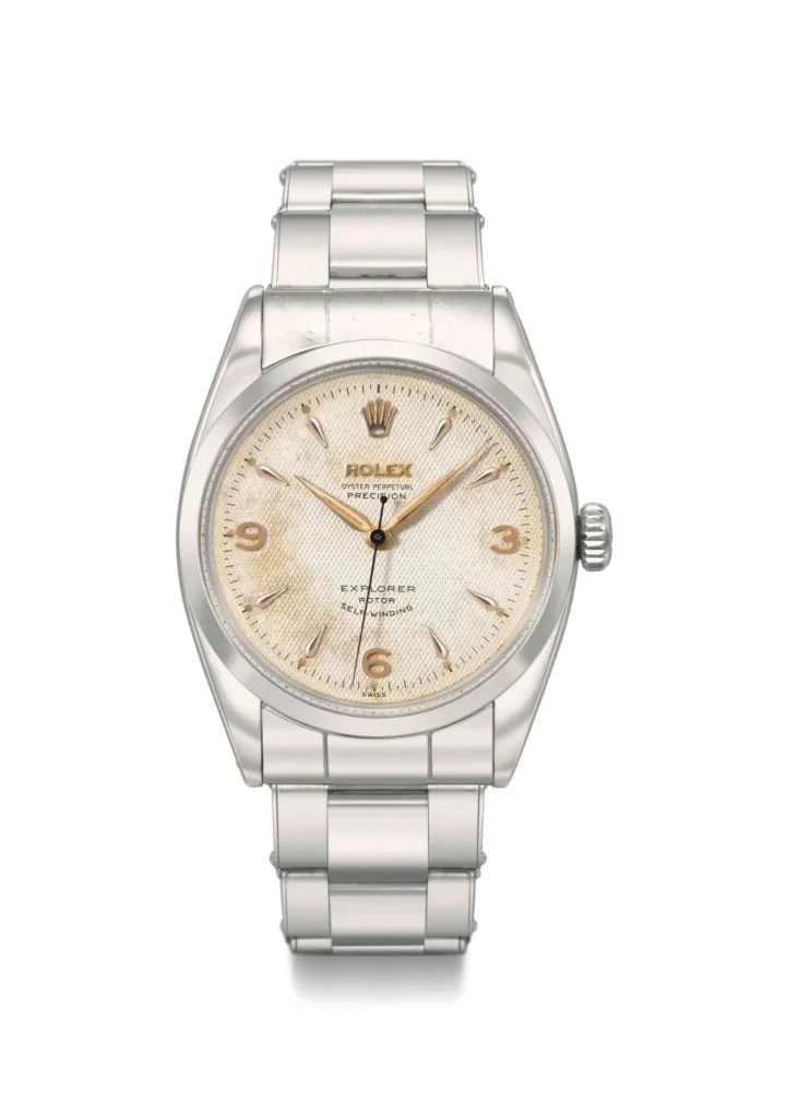 A vintage silver Rolex Explorer 6150 watch with a cream dial and silver hour markers on a metal bracelet.