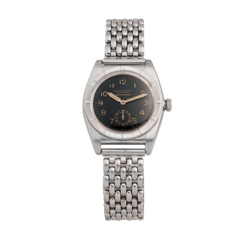 A vintage Rolex Oyster Perpetual 3172 silver wristwatch with a black dial and metal link bracelet is shown on a white background.