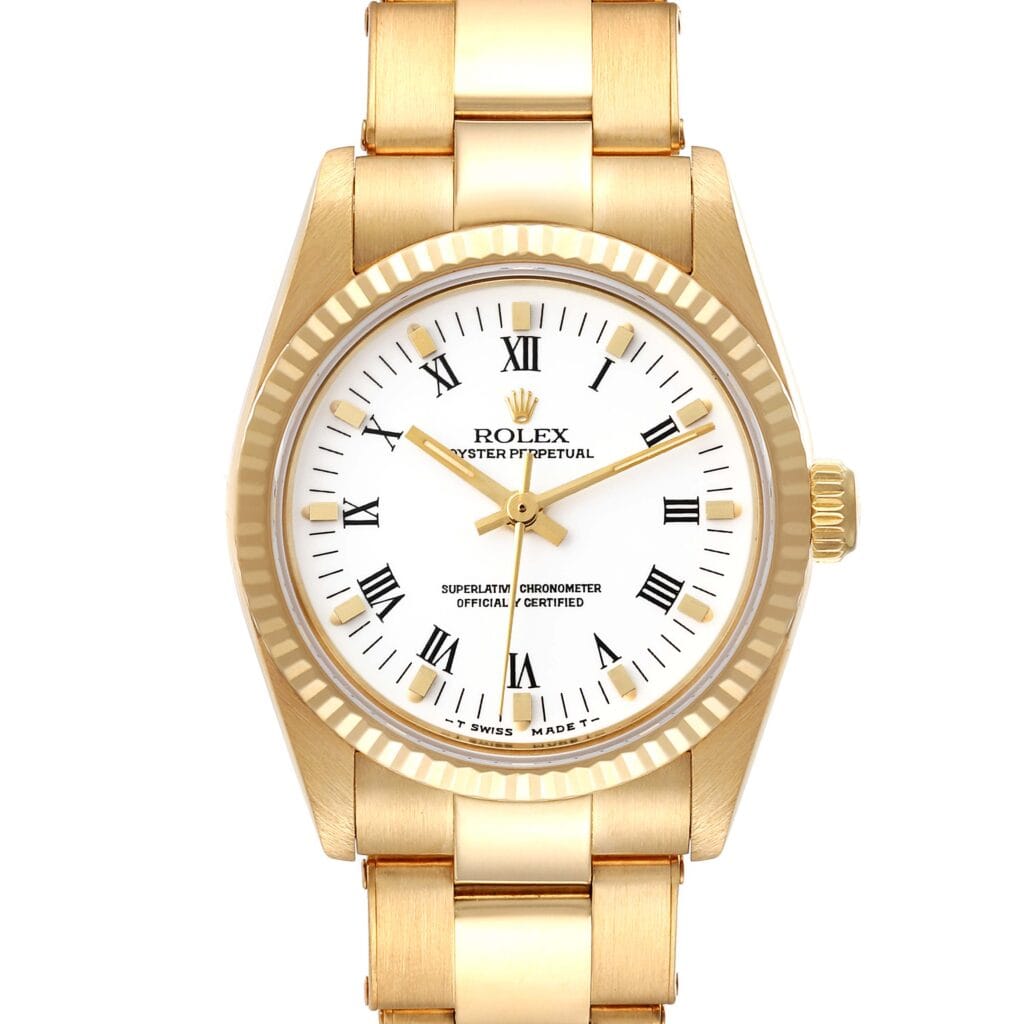 Gold Rolex Oyster Perpetual wristwatch, model 67518, with a white dial, Roman numerals, and a fluted bezel, shown from the front.
