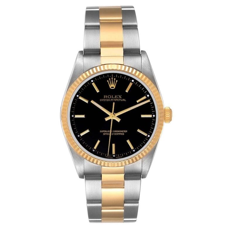 A Rolex Oyster Perpetual 14233 watch featuring a black dial, gold bezel, and an elegant two-tone gold and silver metal bracelet.