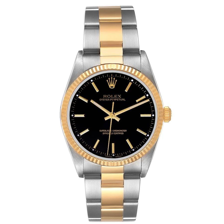 A Rolex Oyster Perpetual 14233 watch featuring a black dial, gold bezel, and an elegant two-tone gold and silver metal bracelet.
