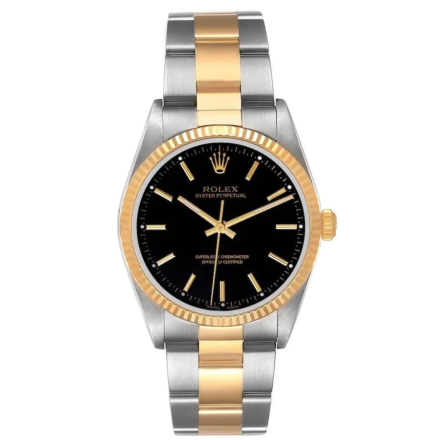 A Rolex Oyster Perpetual 14233 watch featuring a black dial, gold bezel, and an elegant two-tone gold and silver metal bracelet.