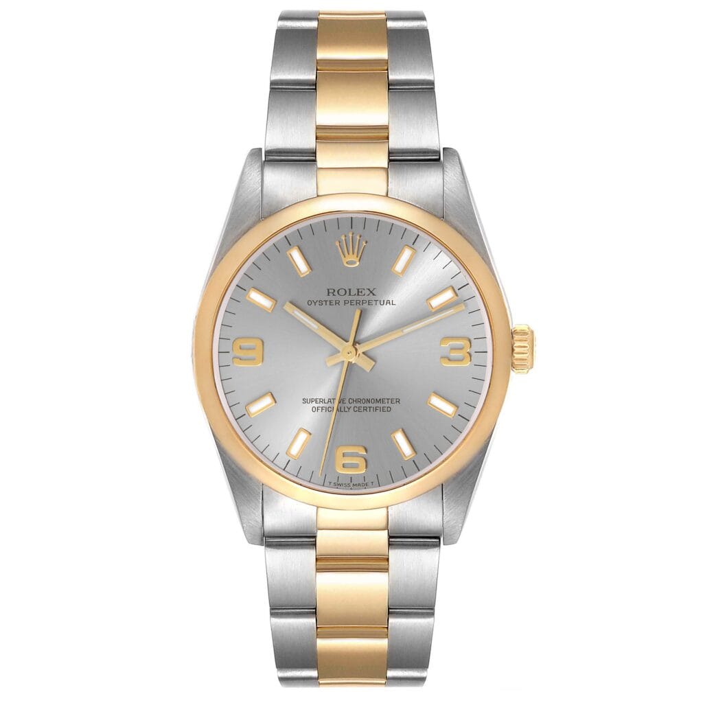 Rolex Oyster Perpetual 14203 watch with a silver and gold band, silver dial, and gold hour markers and hands.