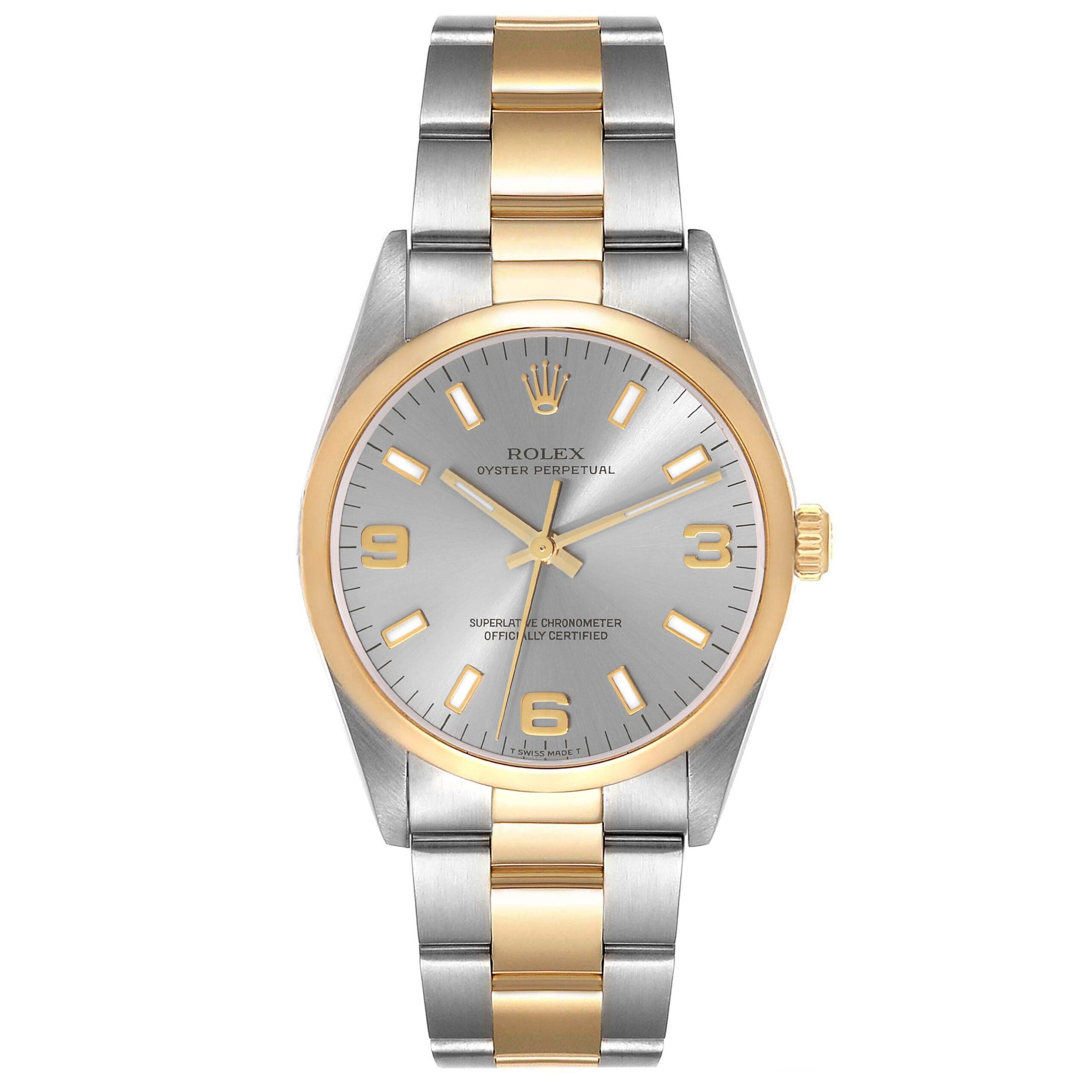 Rolex Oyster Perpetual 14203 watch with a silver and gold band, silver dial, and gold hour markers and hands.