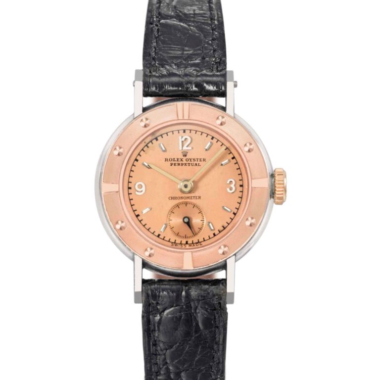 A vintage Rolex Oyster Perpetual wristwatch featuring a pink dial, black leather strap, and silver case.