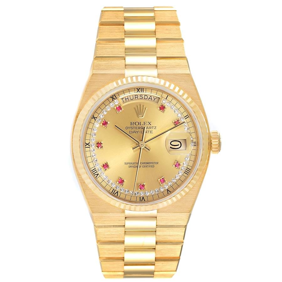 Gold Rolex Oysterquartz 19018 Day-Date watch featuring a gold dial, ruby hour markers, and a Roman numeral day display.
