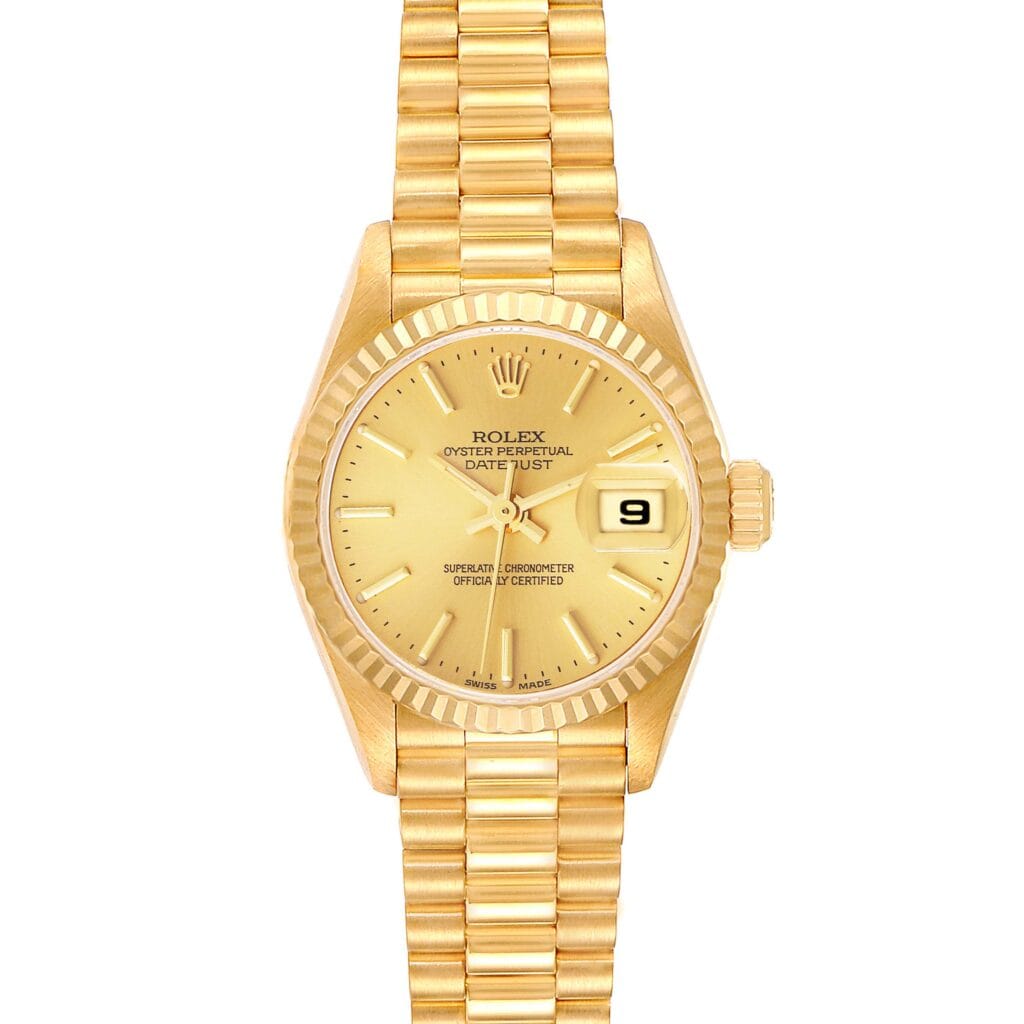 Gold Rolex Datejust 79178 wristwatch with a gold dial, date display, and gold link bracelet, viewed from above.