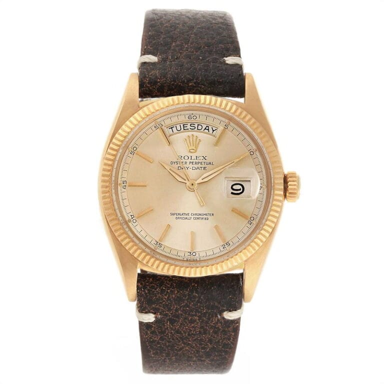 Gold Rolex President 6611 watch with a brown leather strap, day and date display, and cream-colored dial.