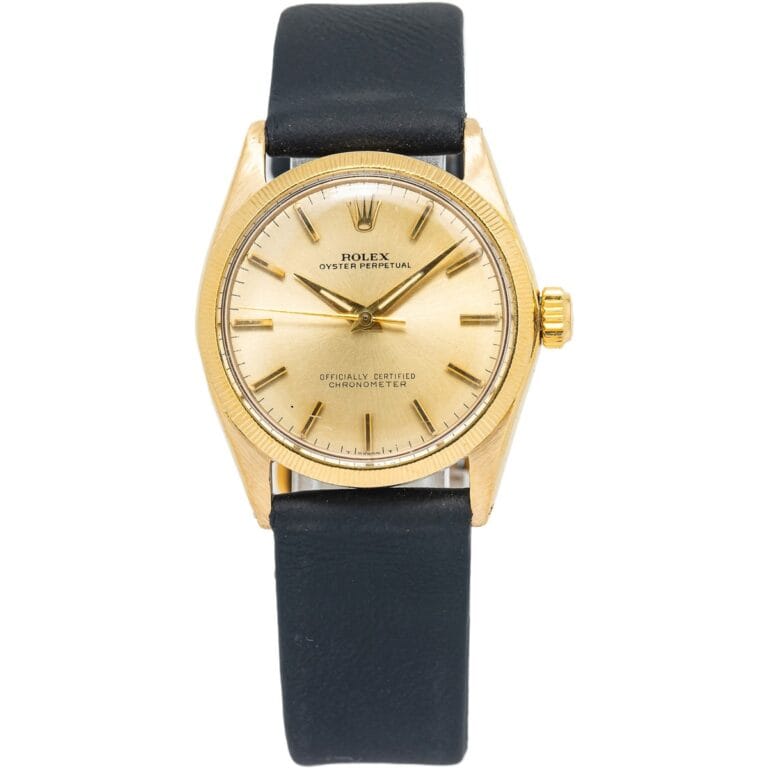 A gold Rolex Oyster Perpetual watch with a black leather strap, a cream dial, and classic Date 6547 detailing.