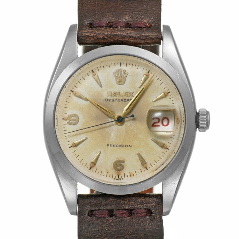 Vintage Rolex Oysterdate Precision 6494 watch with a brown leather strap, cream dial, and date window showing 20 in red.