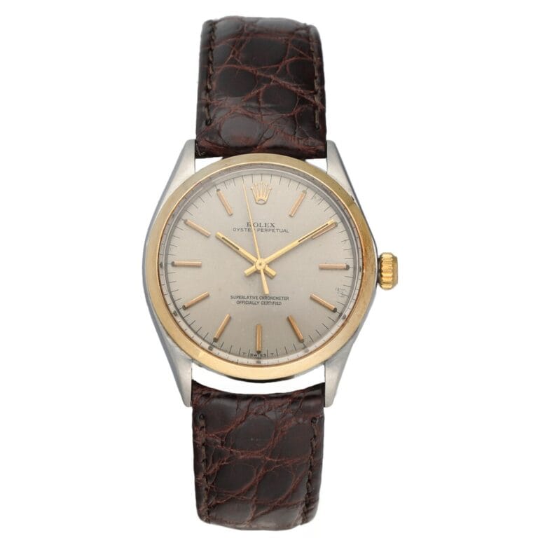 A classic Rolex Air King 1002 wristwatch featuring a brown leather strap and a silver dial with gold accents.
