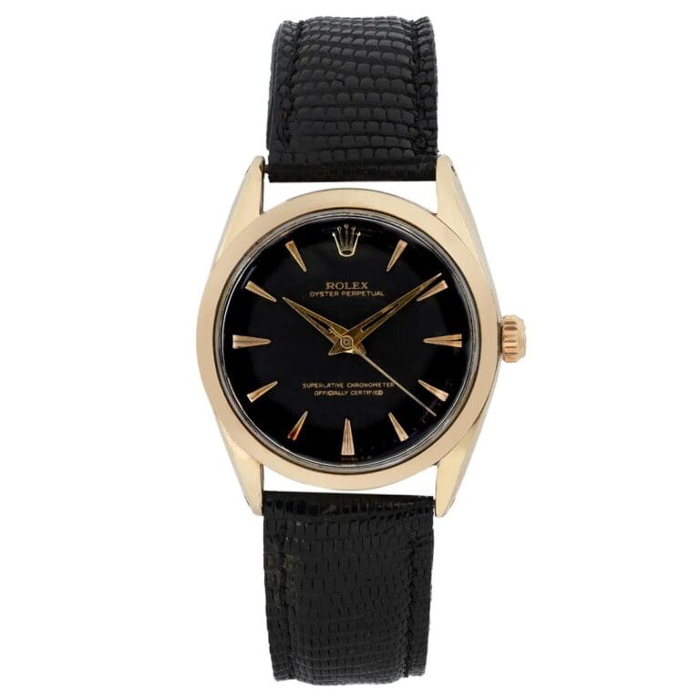 Gold Rolex Oyster Perpetual 1025 watch with a black dial and black textured leather strap against a white background.