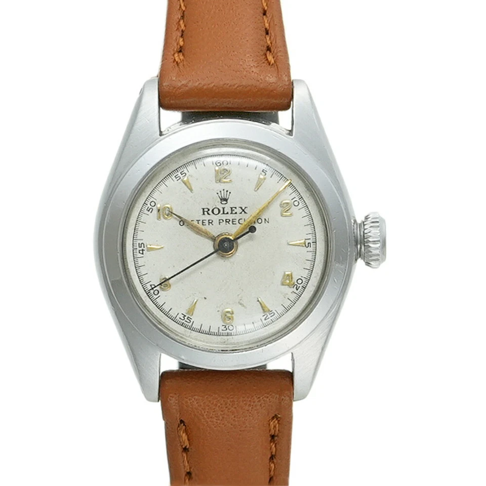 Vintage Rolex Oyster Precision watch with a brown leather strap and a silver dial displaying gold markers, classic to the Rolex Oyster 5004 collection.