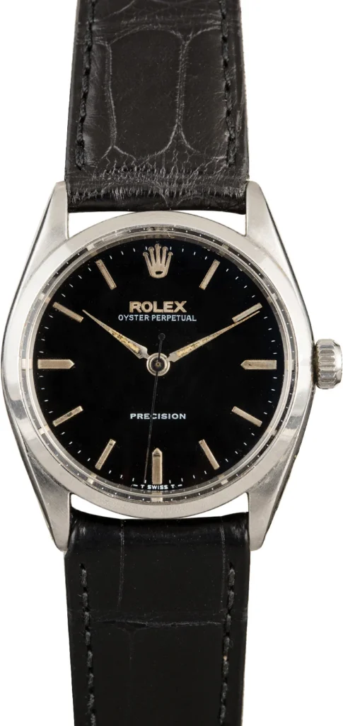 A black dial Rolex Oyster Perpetual 6552 Precision watch with a black leather strap.