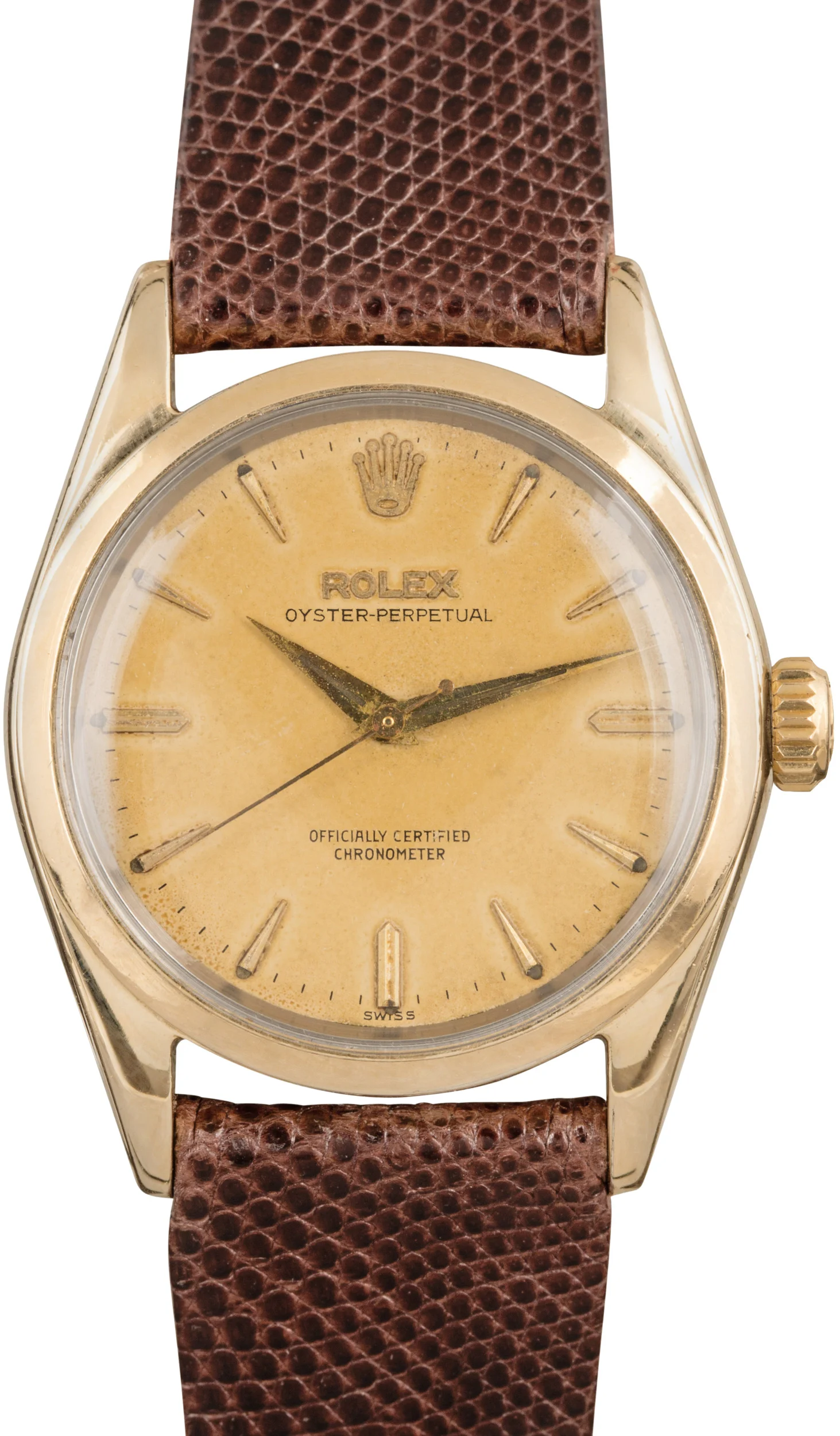 Gold vintage Rolex Oyster Perpetual 6634 watch with a brown leather strap and a worn yellow dial.