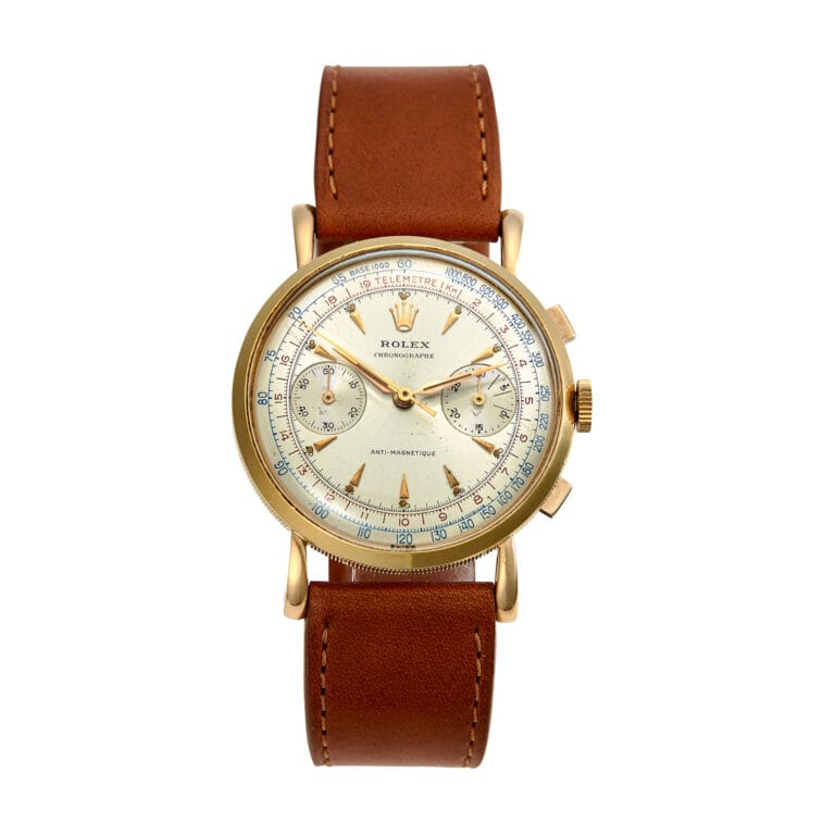 Gold Rolex Chronograph 4062 watch with a brown leather strap and white dial, featuring multiple subdials and striking blue accents.