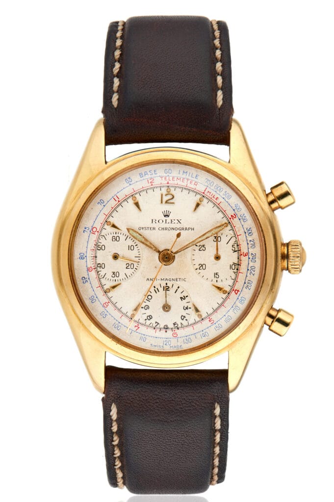 Gold vintage Rolex Chronograph 5034 watch with a brown leather strap and a detailed white dial.