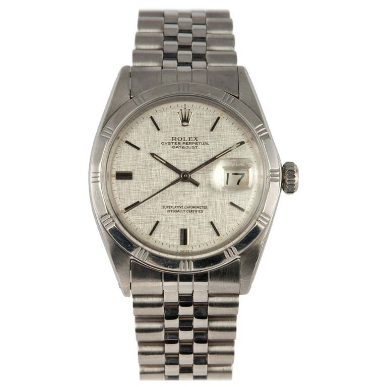 A stainless steel Rolex Datejust 1605 watch with a silver dial and metal bracelet, featuring the date display at 3 o’clock.