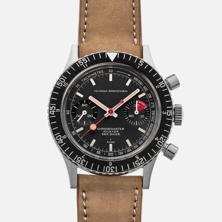 A vintage-style Nivada Grenchen Chronomaster Aviator Sea Diver wristwatch with a black dial, brown leather strap, and silver case.