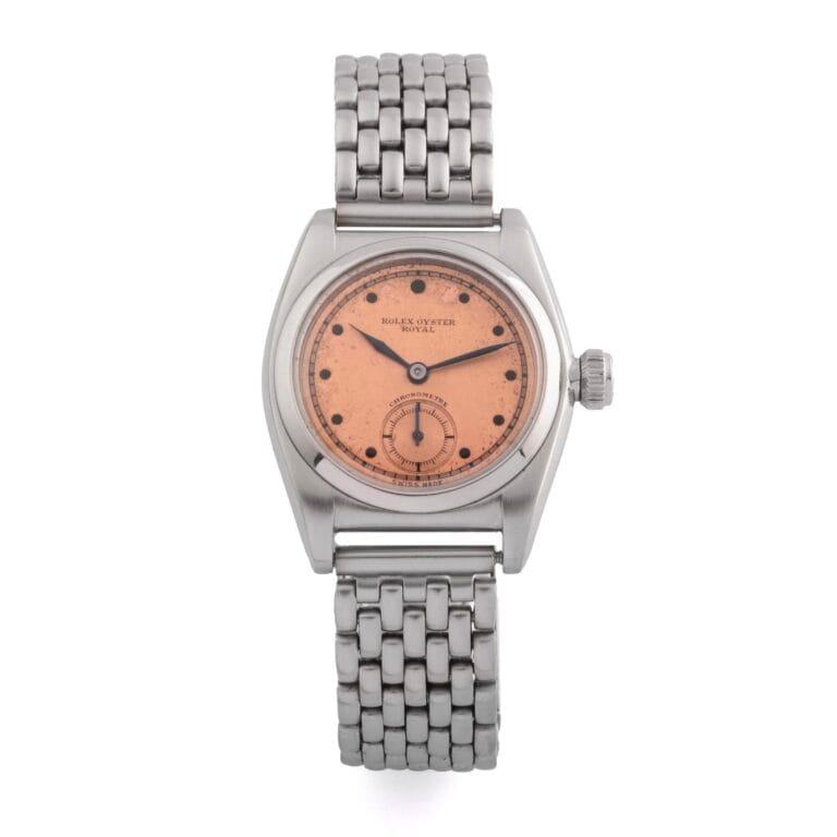 A vintage Rolex Oyster Royal wristwatch from 1873 featuring a pink dial, silver case, and metal link bracelet.