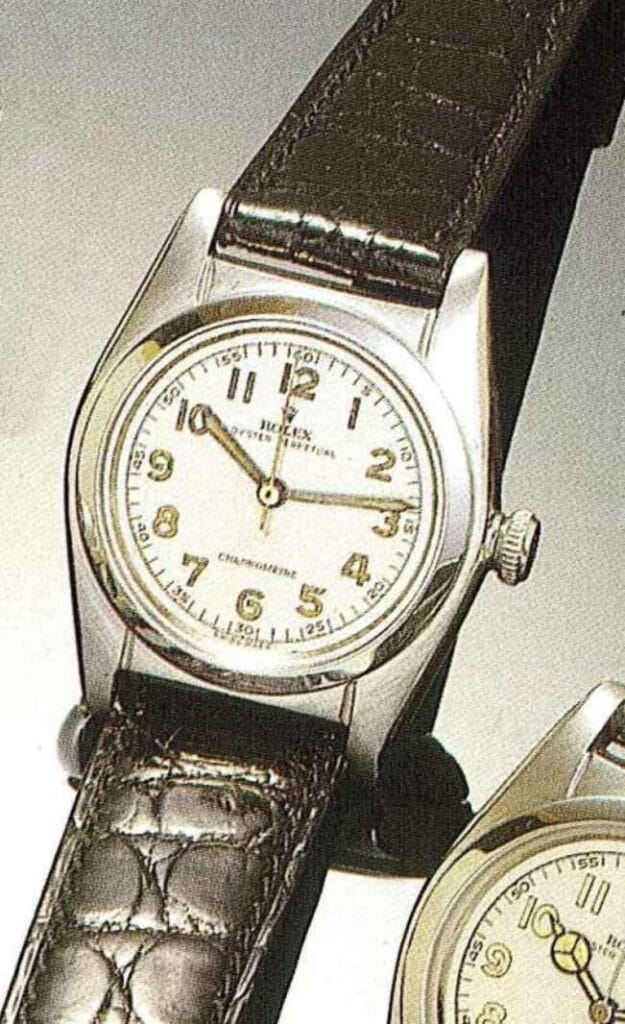 A vintage Rolex Oyster Perpetual 2240 wristwatch featuring a leather strap and a silver-tone dial with Arabic numerals.