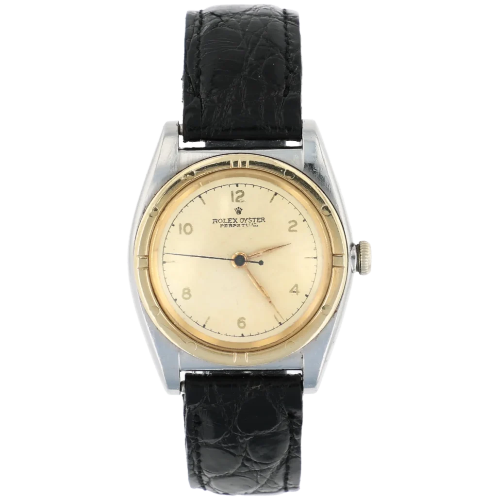 A vintage Rolex Oyster Precision 3372 watch featuring a cream dial, gold bezel, and a classic black leather strap.