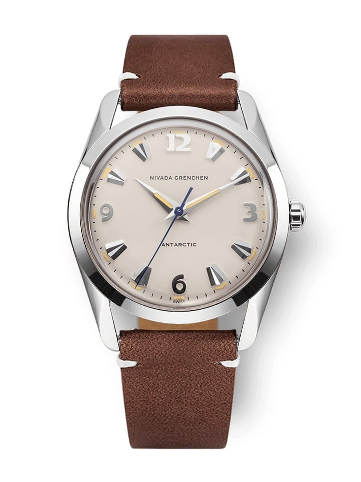 Silver watch with a beige dial, brown leather strap, and silver hour markers, reading Nivada Grenchen Antarctic 35001M14.