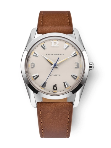 Silver watch with beige dial, brown leather strap, and silver numeral markers, reading Nivada Grenchen Antarctic 35001M16.