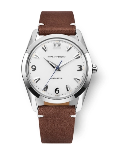 A silver Nivada Grenchen Antarctic wristwatch with a white dial and brown leather strap, showing 10:10 time.