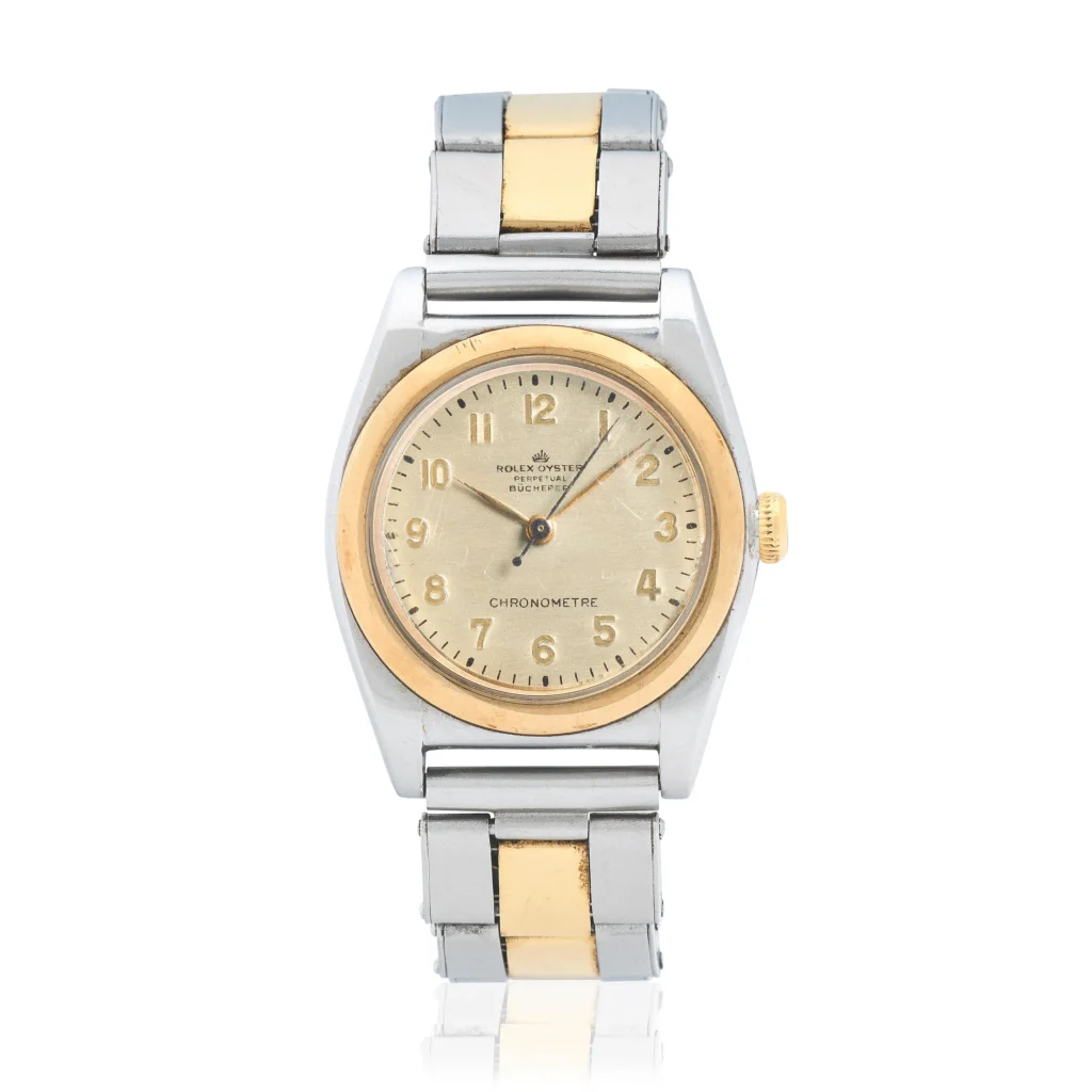 A two-tone Rolex Oyster Perpetual wristwatch featuring a gold and silver band with a round gold bezel on a cream dial. Model 3358.